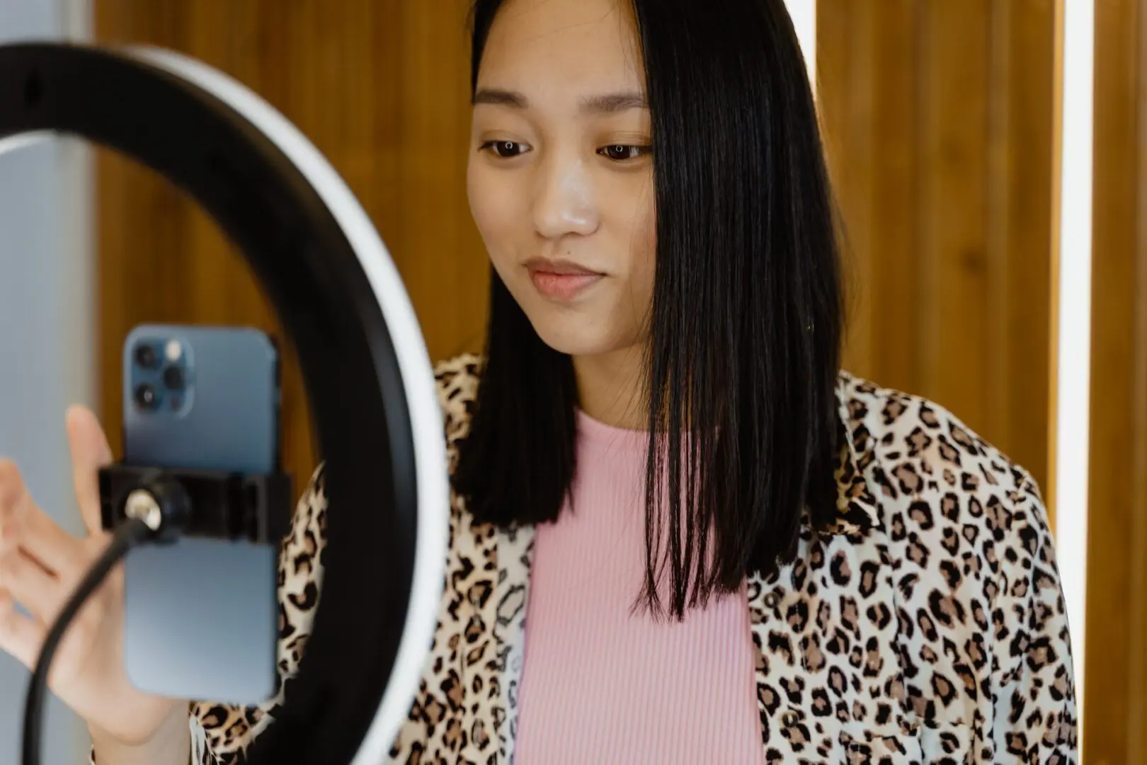 girl create tiktok video in front of white neon light